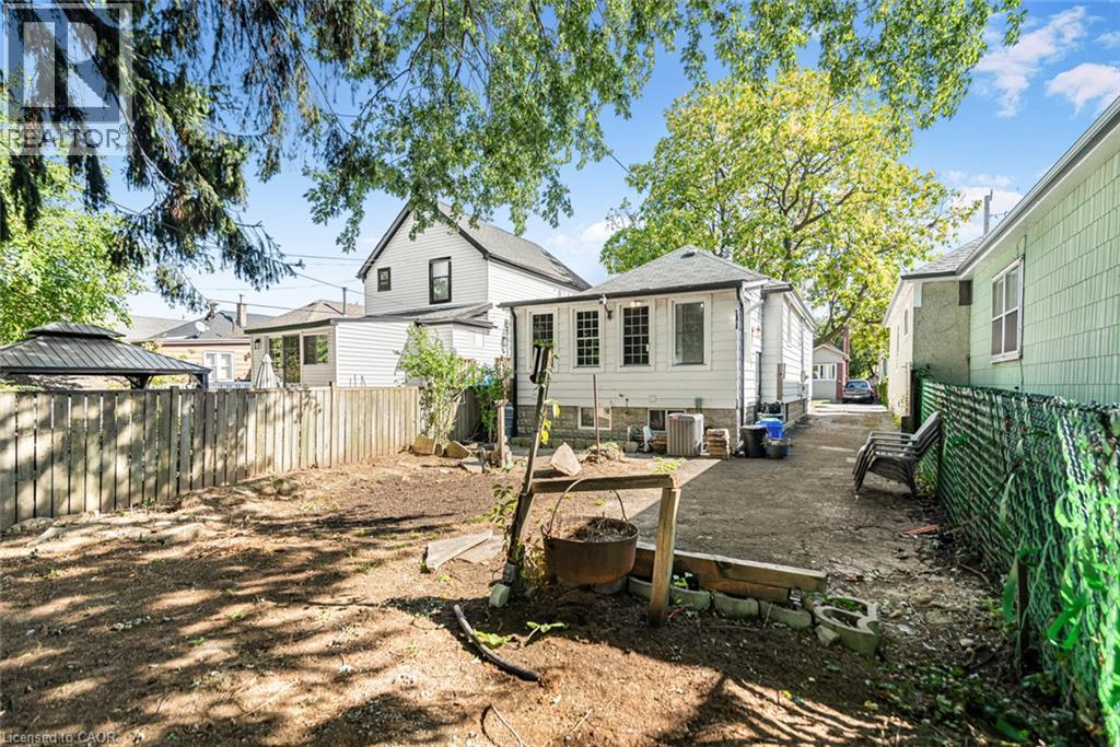 Exterior featuring a fenced property perimeter and a detached structure - 29 Wexford Avenue N, Hamilton, ON