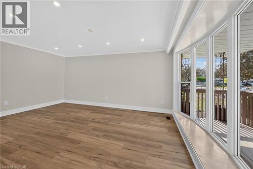 Recessed lighting, wood-finish flooring, white crown molding, white baseboards, and a large bay window - 331 East 17Th Street, Hamilton, ON 