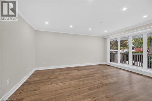 Hardwood-style flooring, white crown molding, recessed lighting, and expansive windows - 331 East 17Th Street, Hamilton, ON 