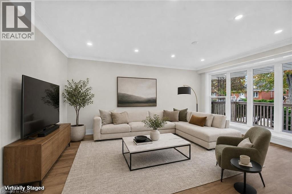 Recessed lighting, wood-finish flooring, and large windows with white trim - 331 East 17Th Street, Hamilton, ON