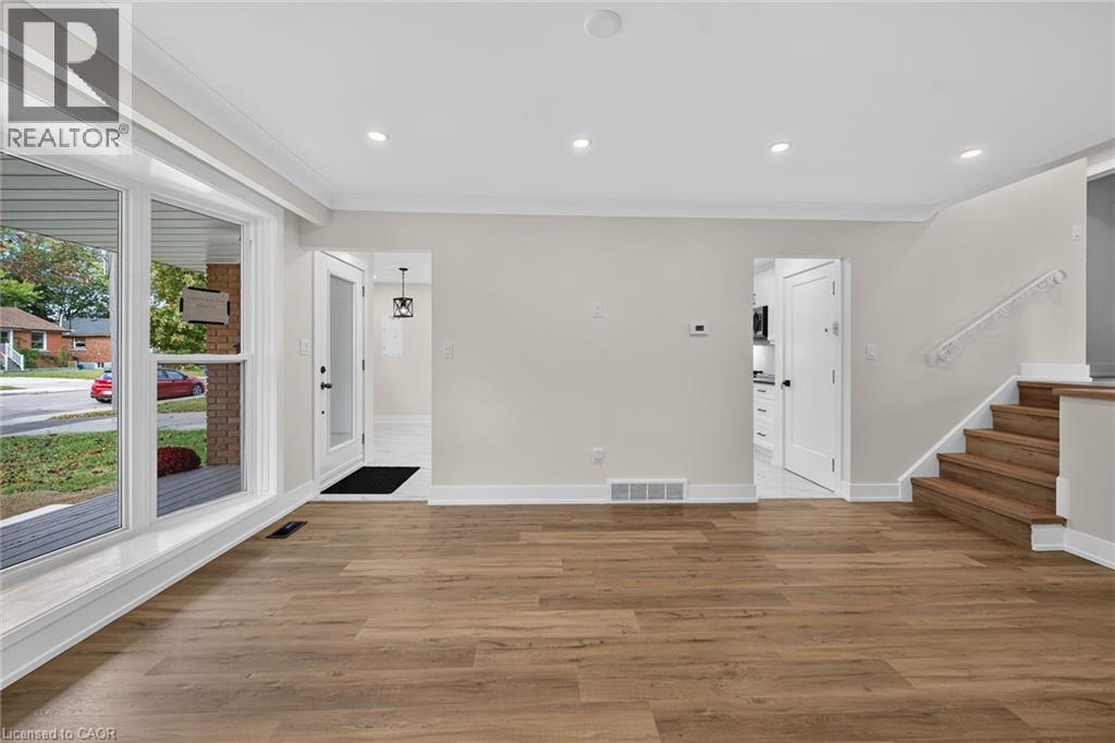 Wood-finish flooring, white trim, and recessed lighting throughout - 331 East 17Th Street, Hamilton, ON