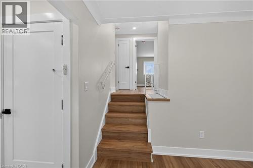 Wood-finish flooring, white trim, and a white stair railing - 331 East 17Th Street, Hamilton, ON 