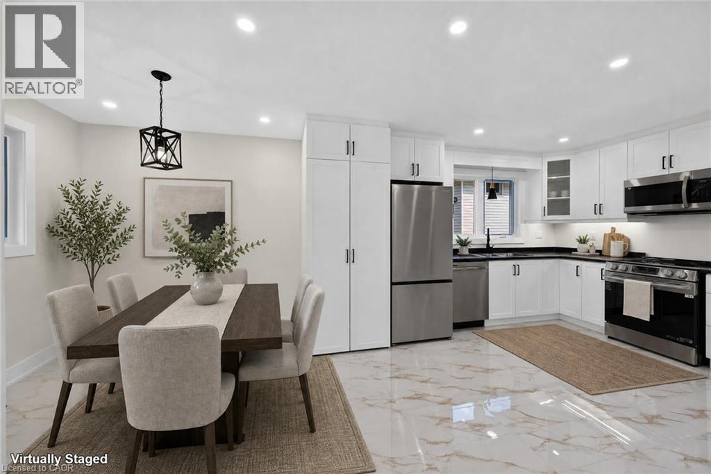 White shaker cabinetry paired with stainless steel appliances and black countertops - 331 East 17Th Street, Hamilton, ON