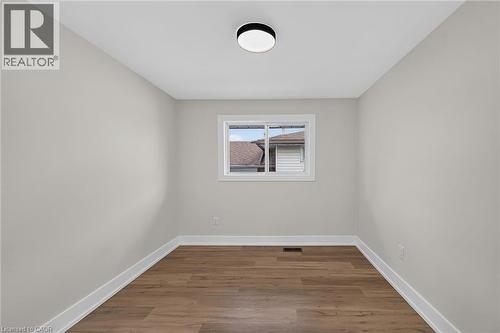 Recessed ceiling light fixture, wood-finish flooring, white trim, and a window with white framing - 331 East 17Th Street, Hamilton, ON 