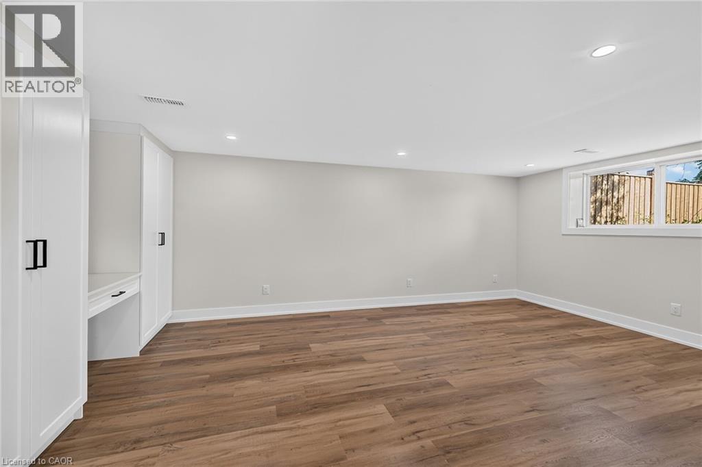 Wood-finish flooring, recessed lighting, and built-in cabinetry with a desk area - 331 East 17Th Street, Hamilton, ON