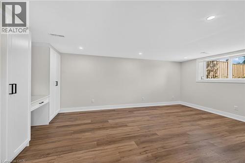 Wood-finish flooring, recessed lighting, and built-in cabinetry with a desk area - 331 East 17Th Street, Hamilton, ON 