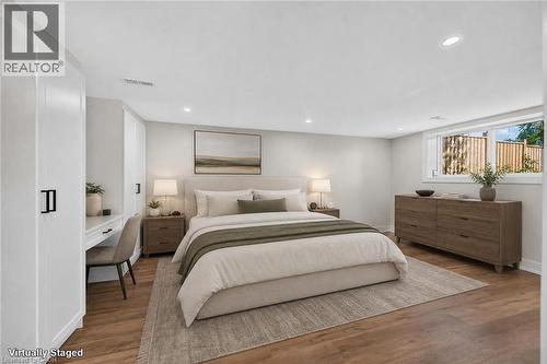 Recessed lighting, wood-finish flooring, and built-in cabinetry with a desk surface - 331 East 17Th Street, Hamilton, ON 
