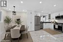 White shaker cabinetry paired with stainless steel appliances and black countertops - 331 East 17Th Street, Hamilton, ON 