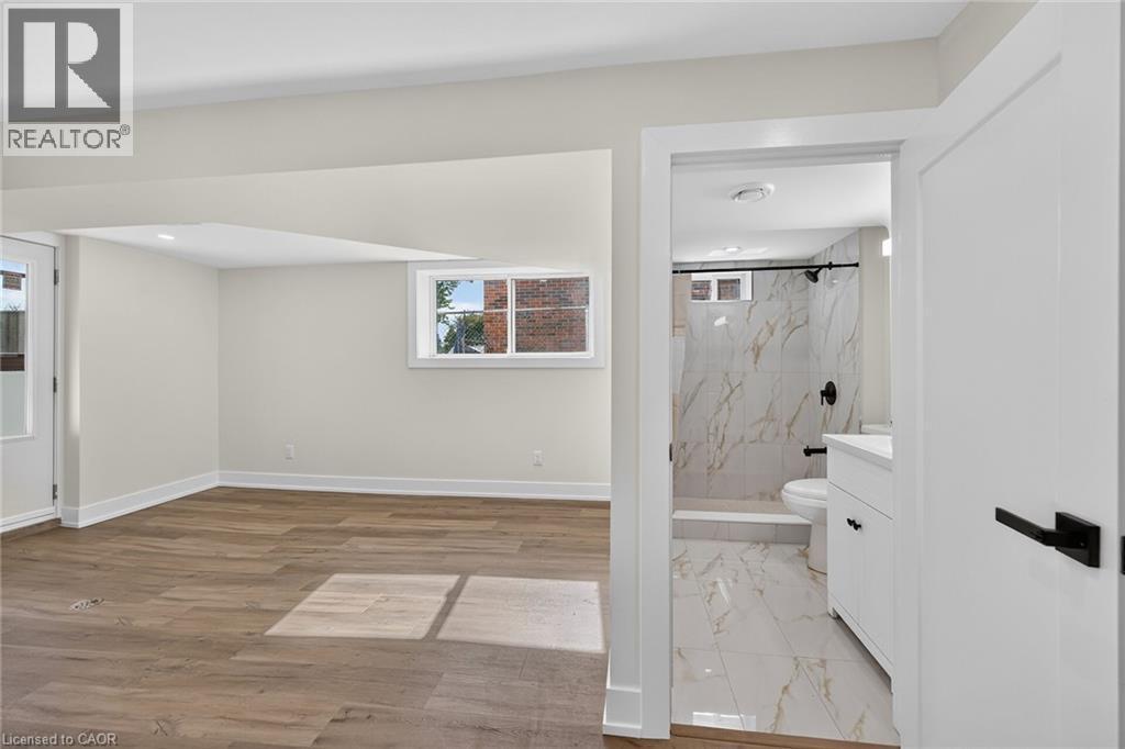 Wood-finish flooring, recessed lighting, and a white trim package - 331 East 17Th Street, Hamilton, ON