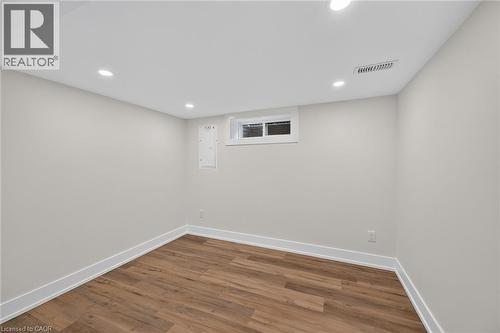 Recessed ceiling lighting, wood-finish flooring, light-colored walls, white trim, and a high window - 331 East 17Th Street, Hamilton, ON 