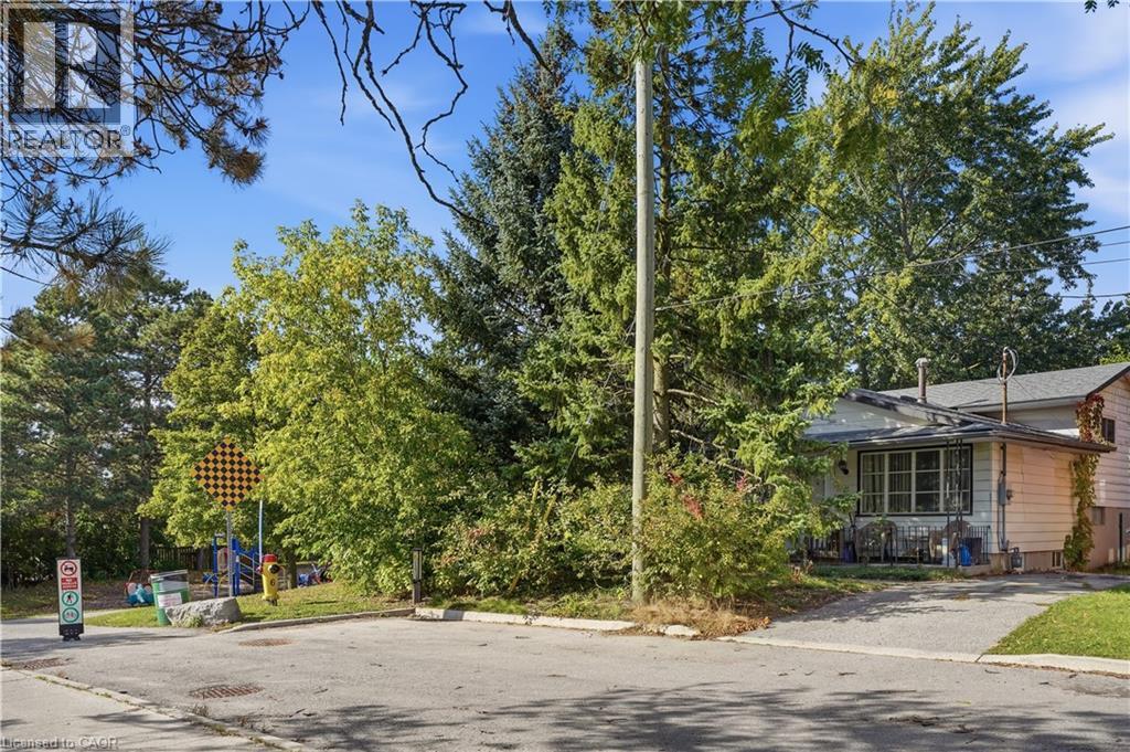 Single-story residence with light-colored siding, a covered front porch, and a paved driveway - 12 Hill Street, Kitchener, ON
