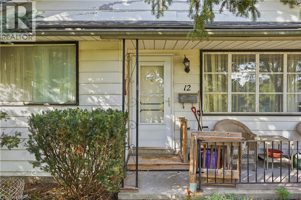 White horizontal siding exterior with a front entry door and a decorative screen door - 12 Hill Street, Kitchener, ON