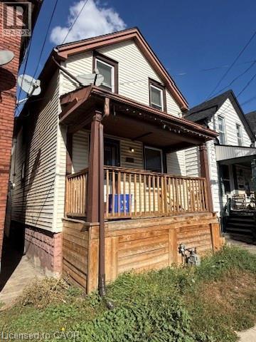 Two-story residence with light-colored siding - 1087 Cannon Street E, Hamilton, ON