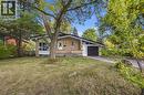 Brick exterior with a peaked roofline, front-facing garage, and a concrete driveway - 246 Hillcrest Road, Cambridge, ON 