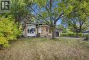 Brick exterior with white trim, prominent front window, covered entryway, attached garage, and paved driveway - 246 Hillcrest Road, Cambridge, ON 