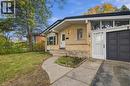 Brick exterior with a prominent front entrance, an integrated garage, a concrete pathway, and a grassy front yard - 246 Hillcrest Road, Cambridge, ON 