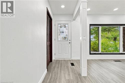 Entryway featuring a decorative glass front door, recessed lighting, and wood-finish flooring - 246 Hillcrest Road, Cambridge, ON 