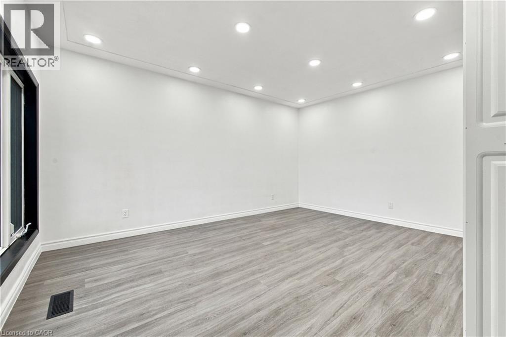Recessed ceiling lighting, crown molding, wood-finish flooring, and white walls - 246 Hillcrest Road, Cambridge, ON