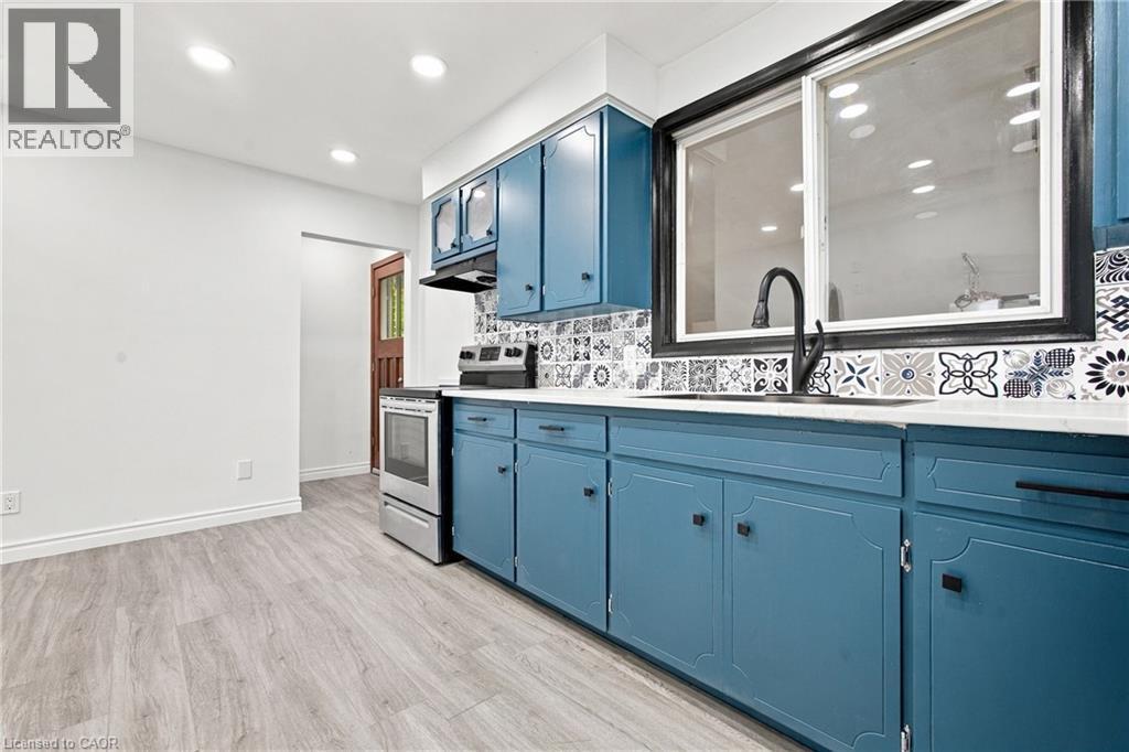 Wood-finish flooring with white walls and recessed lighting - 246 Hillcrest Road, Cambridge, ON