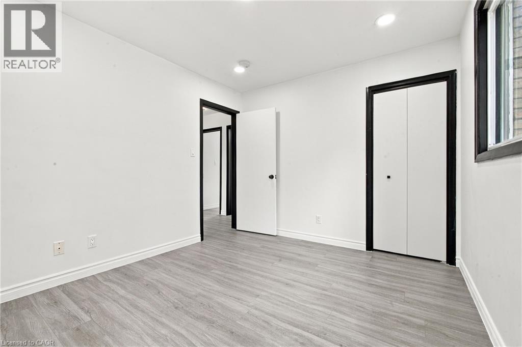 Recessed ceiling lighting, light wood-finish flooring, white walls, and black-trimmed bi-fold closet doors - 246 Hillcrest Road, Cambridge, ON