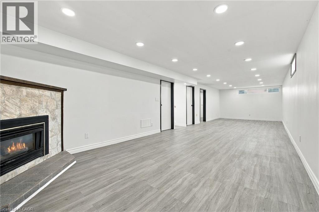 Spacious room featuring wood-finish flooring and multiple recessed ceiling lights - 246 Hillcrest Road, Cambridge, ON