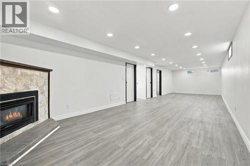 Spacious room featuring wood-finish flooring and multiple recessed ceiling lights - 246 Hillcrest Road, Cambridge, ON 