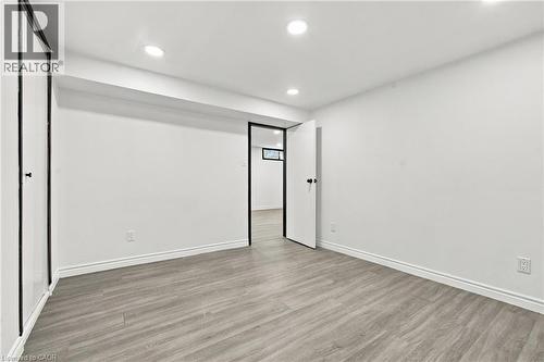 Recessed ceiling lighting, wood-finish flooring, white walls, white trim, and matte black door hardware - 246 Hillcrest Road, Cambridge, ON 