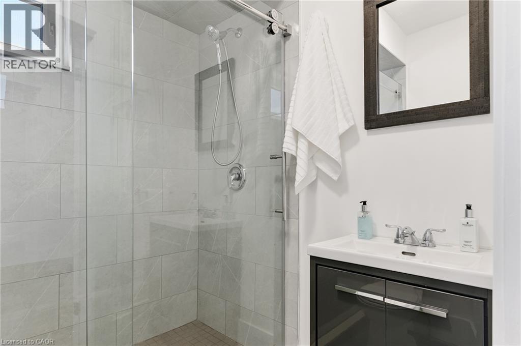 Walk-in shower with clear glass enclosure and tile surround - 164 Wilson Street, Hamilton, ON