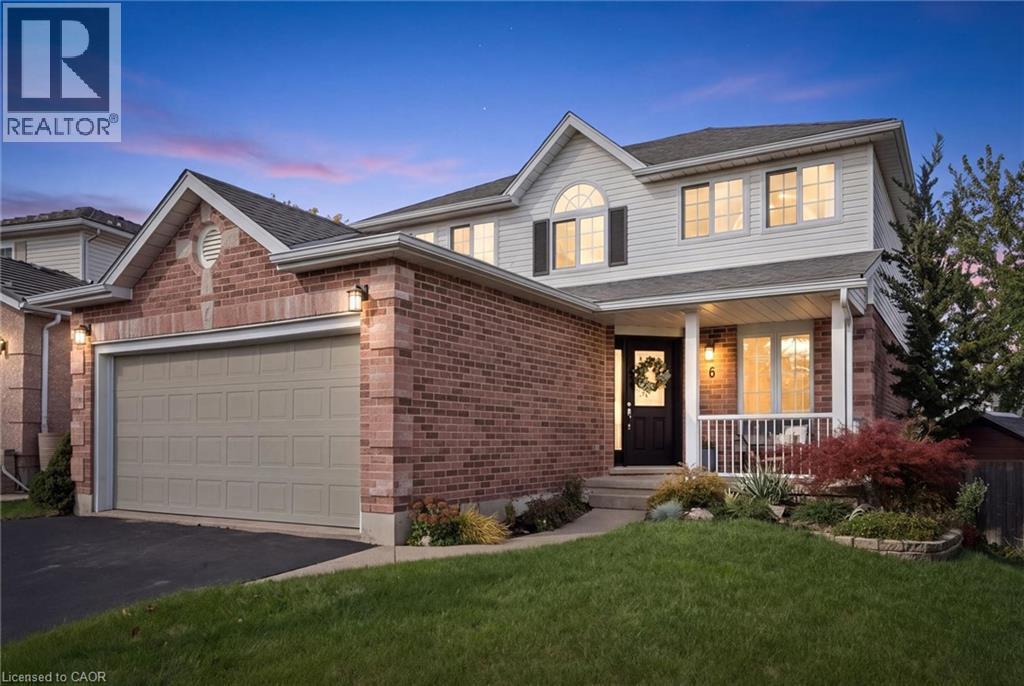 Brick and siding exterior with a covered front porch, an arched window, and a double garage - 6 Branwood Place, Kitchener, ON