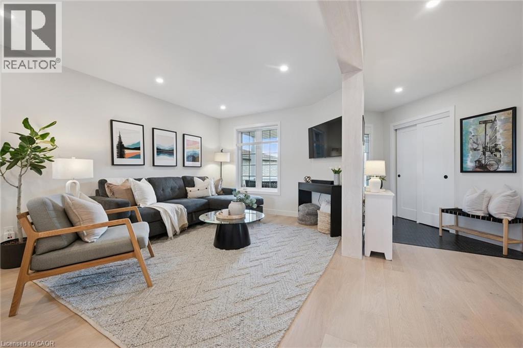 Recessed lighting illuminates the living space featuring light wood-finish flooring - 6 Branwood Place, Kitchener, ON