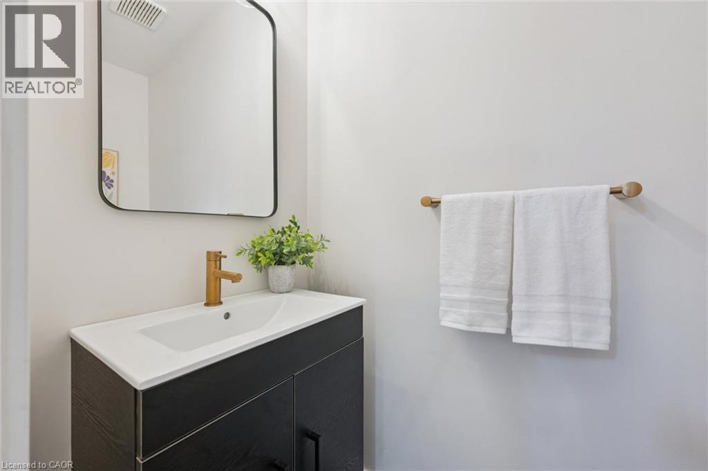 Integrated vanity with a white countertop and rectangular undermount sink - 6 Branwood Place, Kitchener, ON