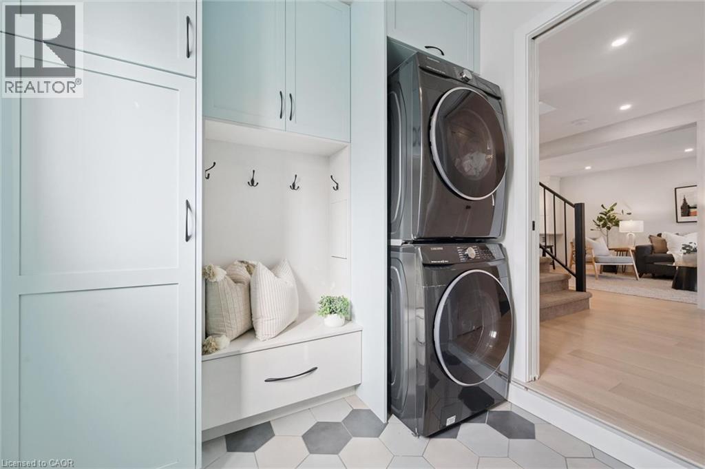 Built-in cabinetry, mudroom bench with storage, and integrated coat hooks. Stackable laundry. - 6 Branwood Place, Kitchener, ON