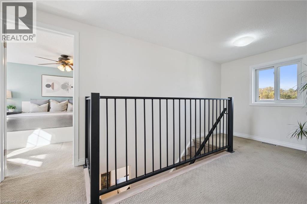 Carpeted landing with black metal railing - 6 Branwood Place, Kitchener, ON