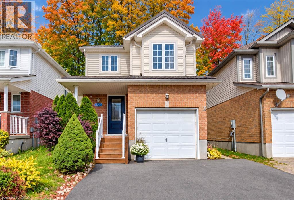 Brick and siding exterior with a single-car garage - 327 Oprington Place, Kitchener, ON