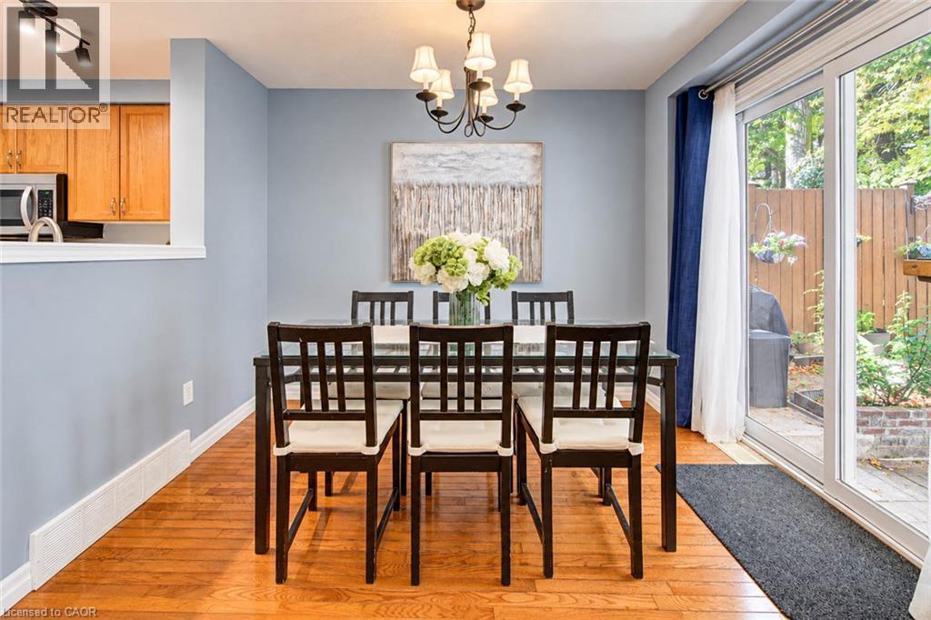 Wood-finish flooring with a partial wall opening to an additional room - 327 Oprington Place, Kitchener, ON