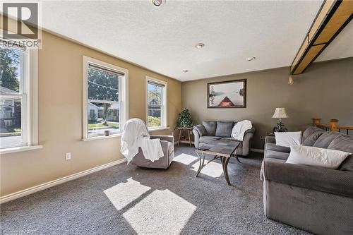 Recessed ceiling lighting, exposed wood-finish beam, light-toned wall paint, multiple windows, and carpeted flooring - 74 Selkirk Street, Cambridge, ON 
