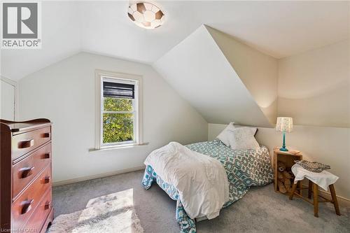 Vaulted ceiling with angled walls, recessed window, wall-to-wall carpeting, and flush mount ceiling light - 74 Selkirk Street, Cambridge, ON 