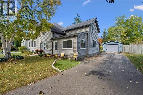 Exterior featuring horizontal siding, multiple windows, a paved driveway, and a detached garage - 74 Selkirk Street, Cambridge, ON 