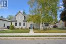 Two-story residence featuring light gray siding, a prominent front gable, and a vibrant blue entry door - 74 Selkirk Street, Cambridge, ON 