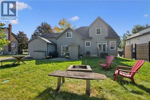 Rear exterior with light gray siding, multi-level roofline, and a patio area - 74 Selkirk Street, Cambridge, ON 