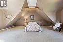 Expansive carpeted room featuring sloped ceilings, a prominent exposed beam, and neutral wall tones - 74 Selkirk Street, Cambridge, ON 