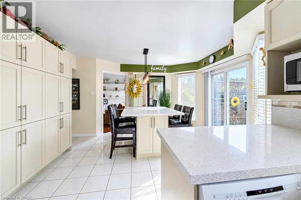 Family size kitchen with large pantry, tile floors and walk-out to deck - 11 Peregrine Crescent, Cambridge, ON