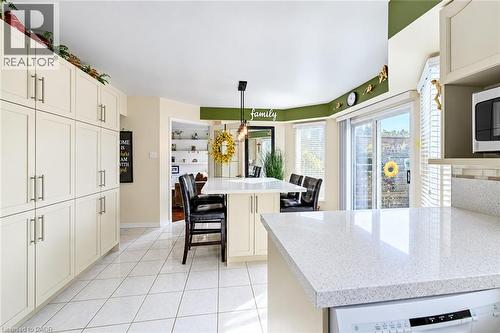 Family size kitchen with large pantry, tile floors and walk-out to deck - 11 Peregrine Crescent, Cambridge, ON 