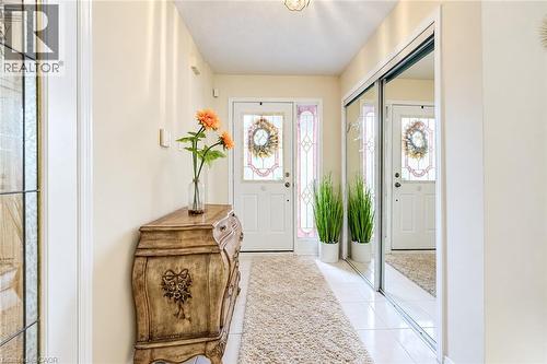 Foyer with tile floors and large closet - 11 Peregrine Crescent, Cambridge, ON 