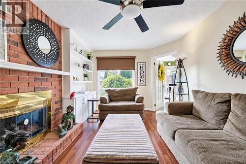 Bright family room features large window, gas fireplace & built-in shelves. - 11 Peregrine Crescent, Cambridge, ON 