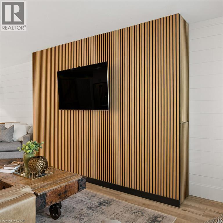 Custom wood-slat accent wall featuring vertical graining, horizontal plank wall cladding, and wood-finish flooring - 361 Lee Circle, Waterloo, ON