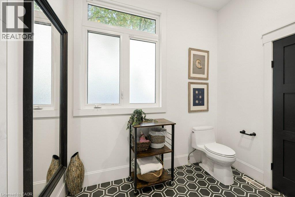 Geometric hexagon floor tiling, frosted glass window with transom, and solid-core door with matte black hardware - 361 Lee Circle, Waterloo, ON
