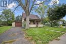 Single-story residence featuring a covered front porch, asphalt-paved driveway, attached garage, and exterior horizontal siding - 1279 Hamilton Street, Cambridge, ON 