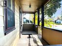 Covered front porch featuring wood-plank flooring, horizontal siding, and a solid-surface railing - 1279 Hamilton Street, Cambridge, ON 