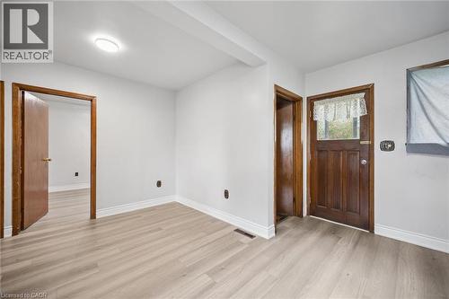 Wood-finish flooring, solid wood doors with matching door casings, and exterior door featuring an inset glass panel - 1279 Hamilton Street, Cambridge, ON 